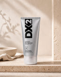 DX2 Shampoo Anti-Canas, tubo de 150 ml sobre travertino, vista frontal