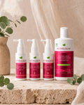 Set Sérum Anticaída Nutrigrow: tres sérums de 60 ml junto al shampoo de regalo sobre travertino